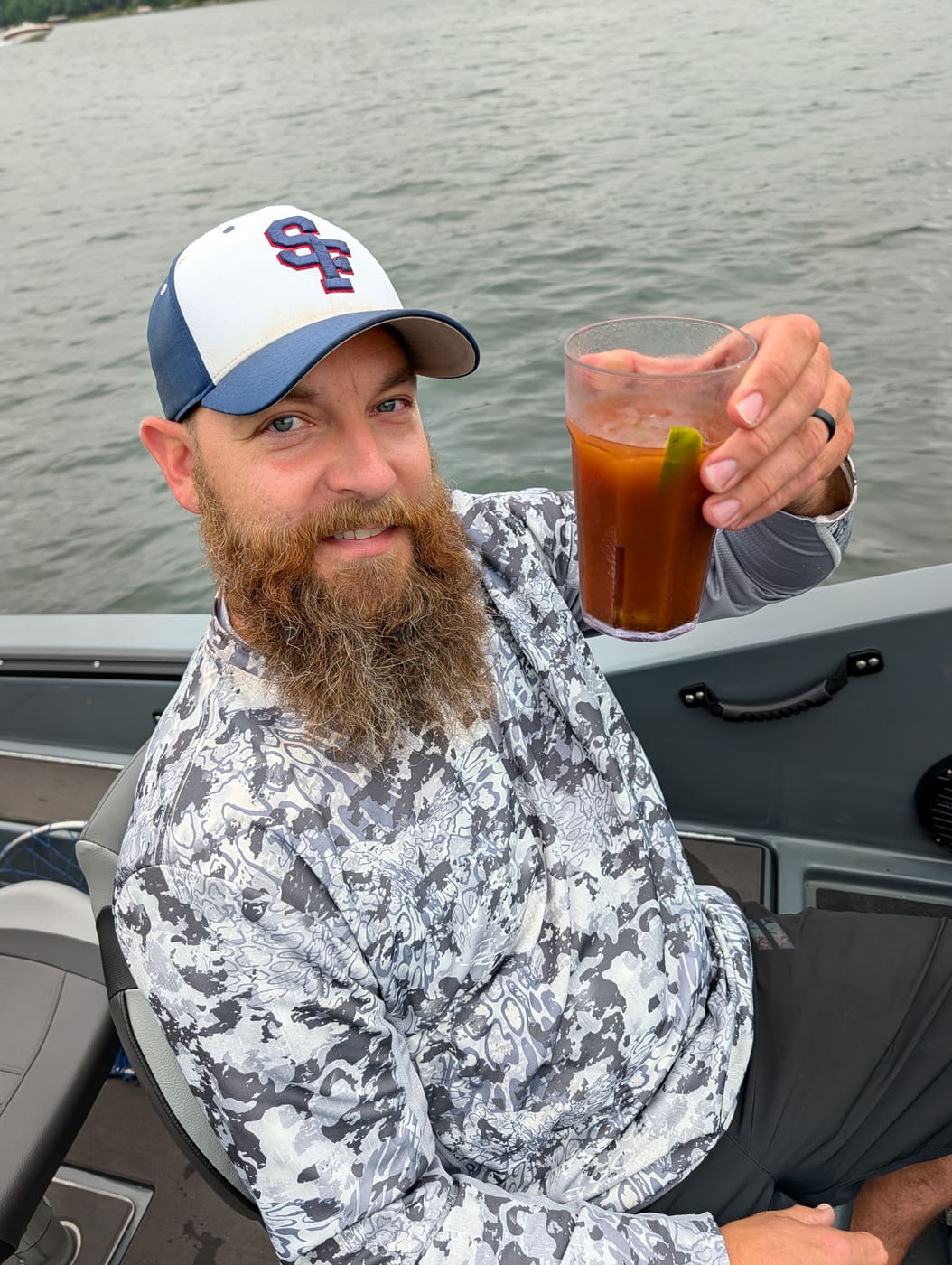 Angler relaxing on the boat with a bloody mary