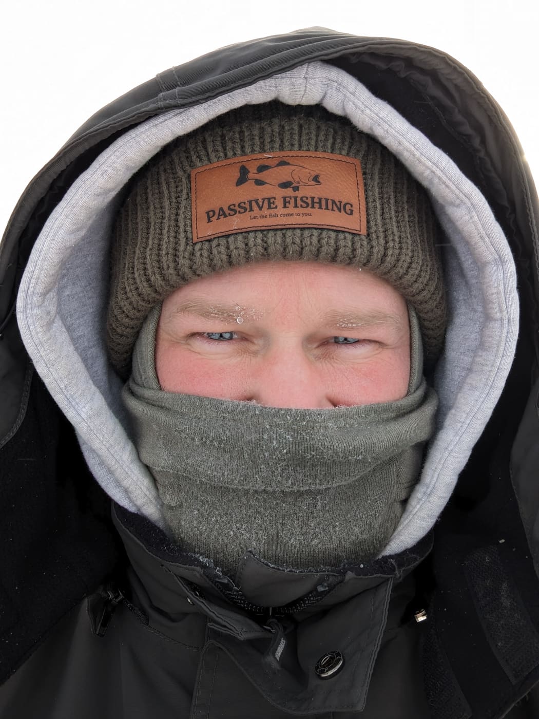 Selfie on the ice wearing a Passive Fishing beanie