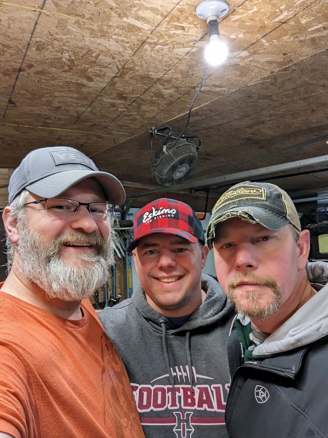 Three anglers in a garage selfie